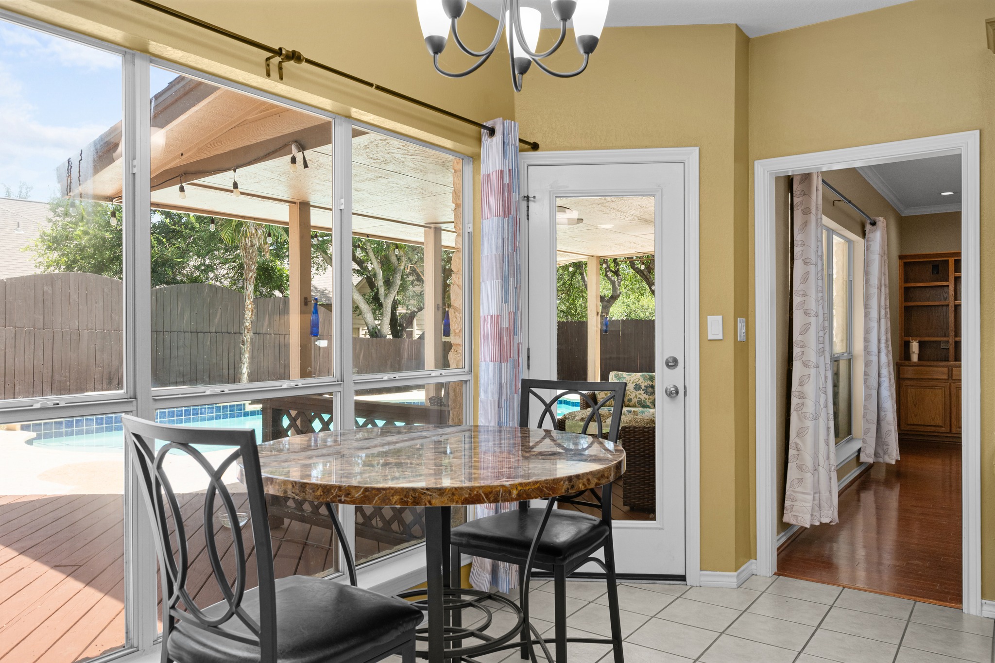 108 Thornwood Road Georgetown, TX 78628 - Photo 17 of 40 A cozy breakfast area offering serene poolside views and easy outdoor access.