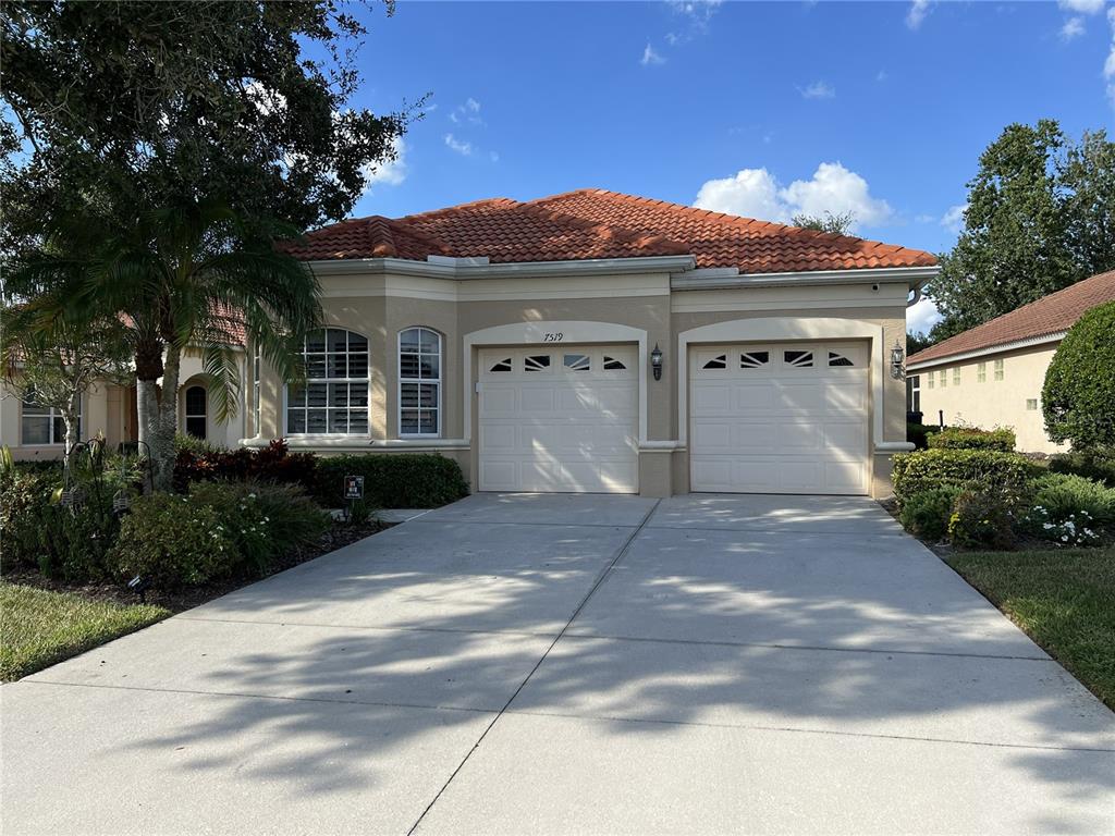 a front view of a house with a yard and garage
