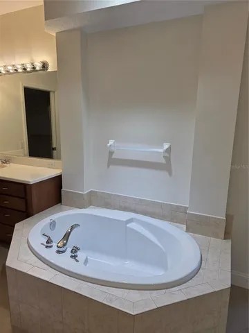 a bath tub sitting next to a white sink