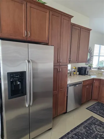 a kitchen with a refrigerator and cabinets