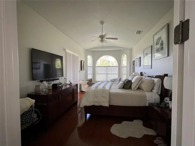 a bedroom with a bed and a flat screen tv