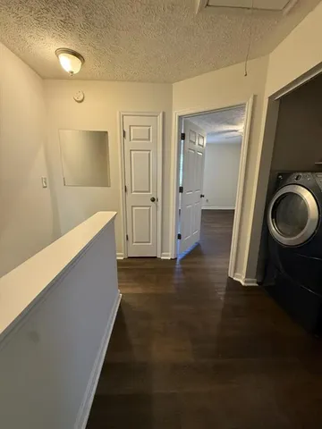 a view of a hallway with wooden floor