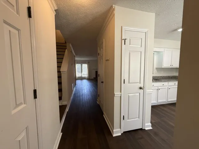 a view of hallway with wooden floor