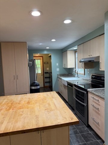 30 Groton Road Shirley, MA 01464 - Photo 8 of 25 a large kitchen with granite countertop a stove top oven a sink a counter space and cabinets