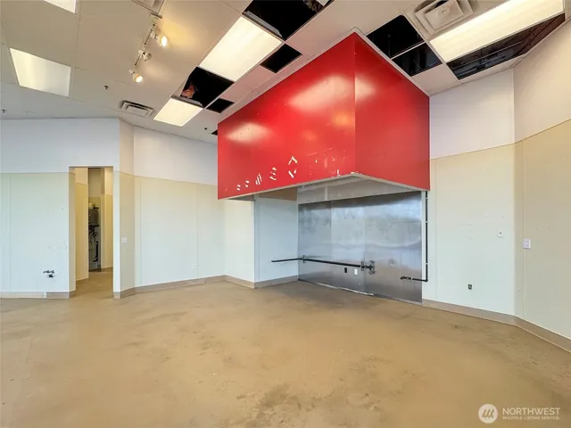 an empty room with closet and windows