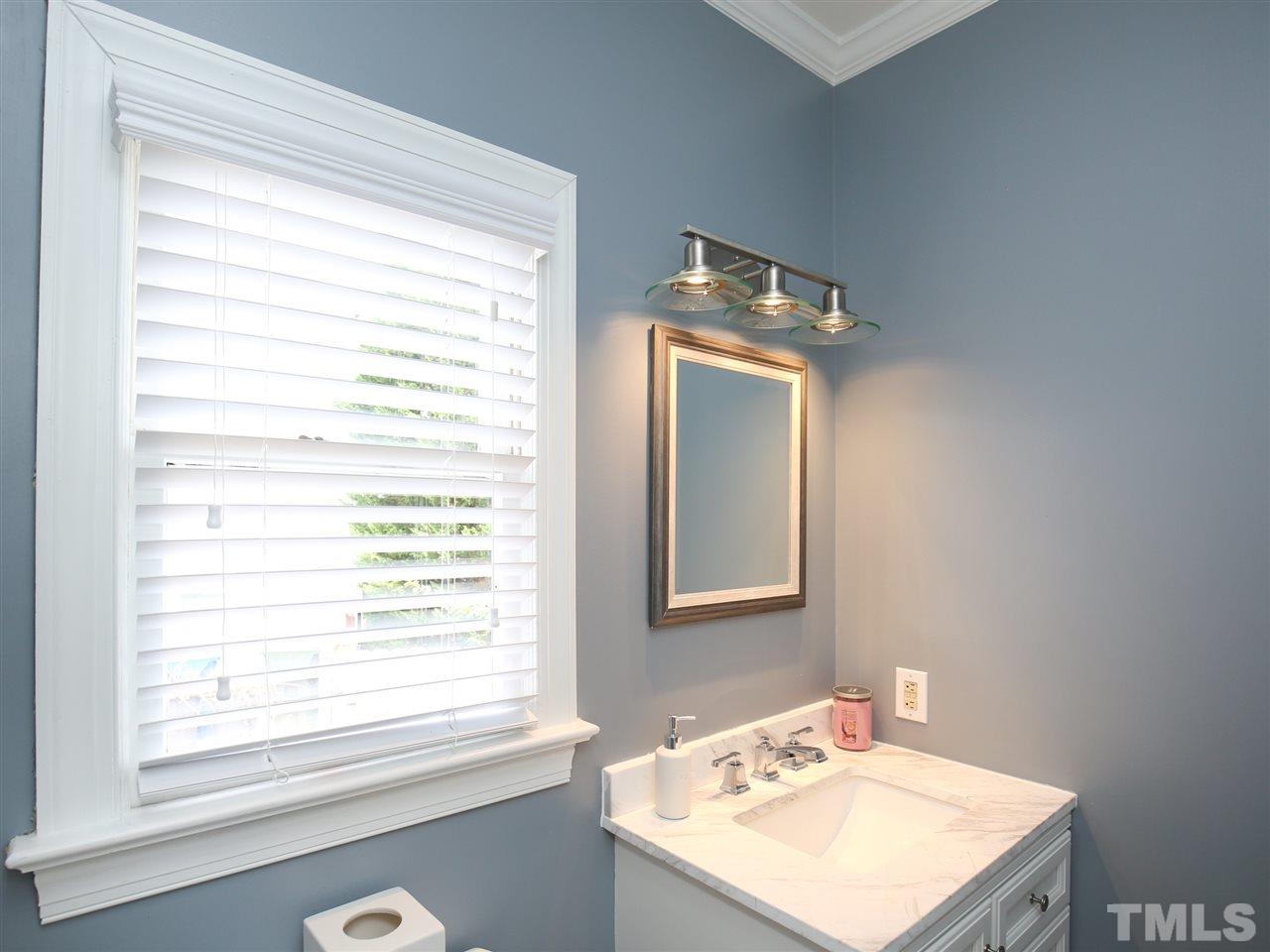 2116 Osprey Circle Raleigh, NC 27615 - Photo 14 of 25 All new powder room.. cabinet, fixtures, lighting, flooring all replaced!