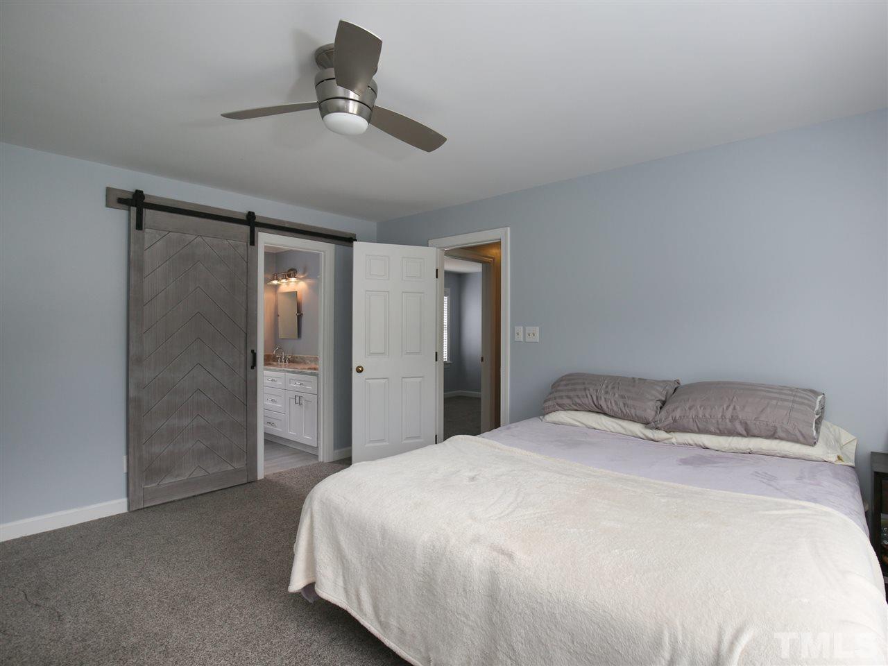 2116 Osprey Circle Raleigh, NC 27615 - Photo 15 of 25 Spacious master bedroom with barn style door leading to master bathroom!
