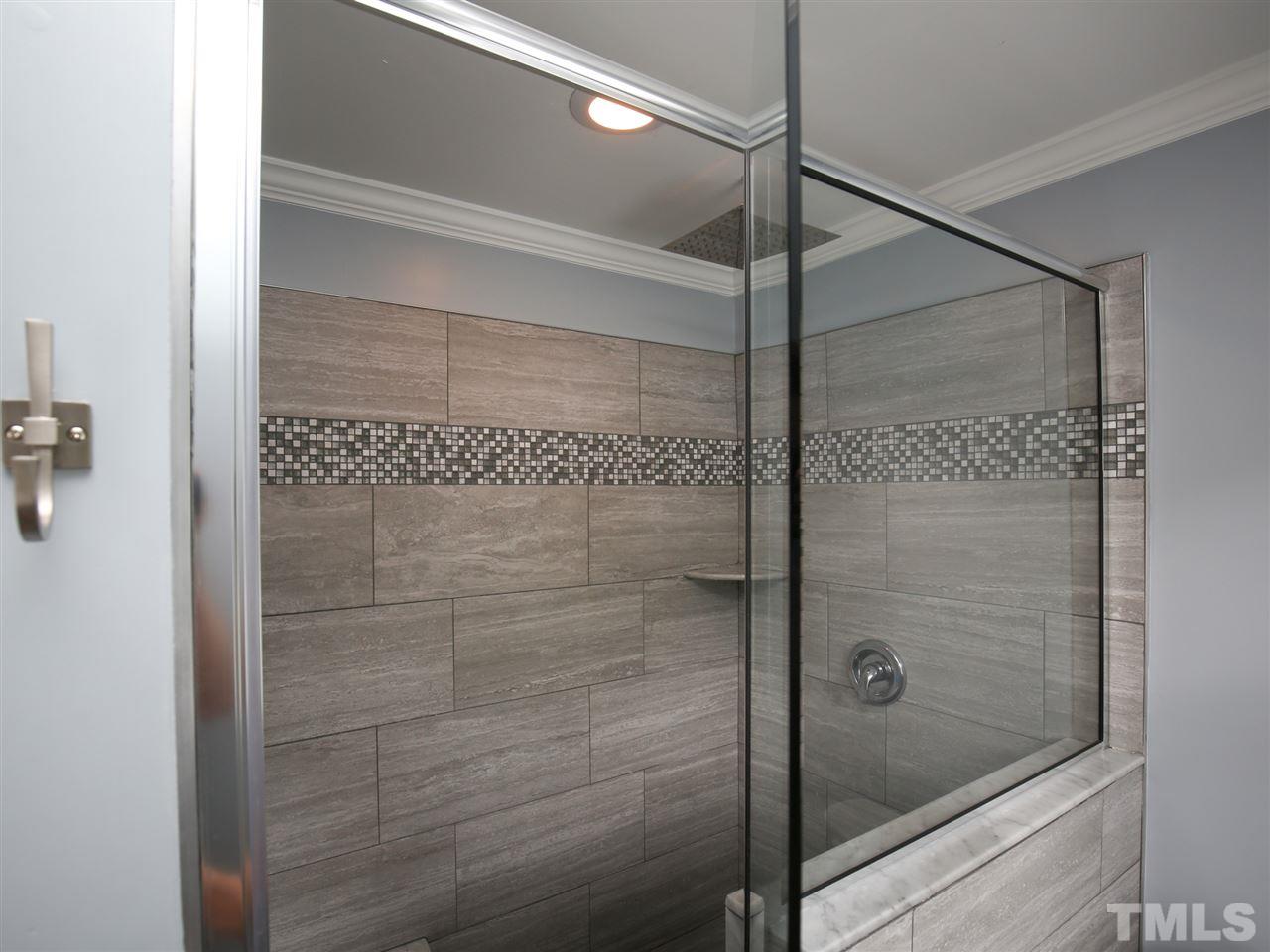 2116 Osprey Circle Raleigh, NC 27615 - Photo 18 of 25 Huge master shower featuring river rock flooring & semi frameless shower door
