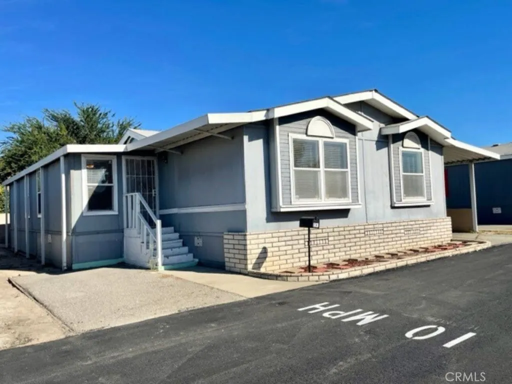 1166 South Riverside Avenue, Unit 83 Rialto, CA 92376 - Photo 1 of 1 a front view of a house with a garage