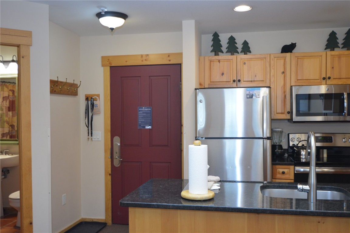 172 Copper Circle, Unit 107 Copper Mountain, CO 80443 - Photo 13 of 25 a white refrigerator freezer and a stove sitting inside of a kitchen
