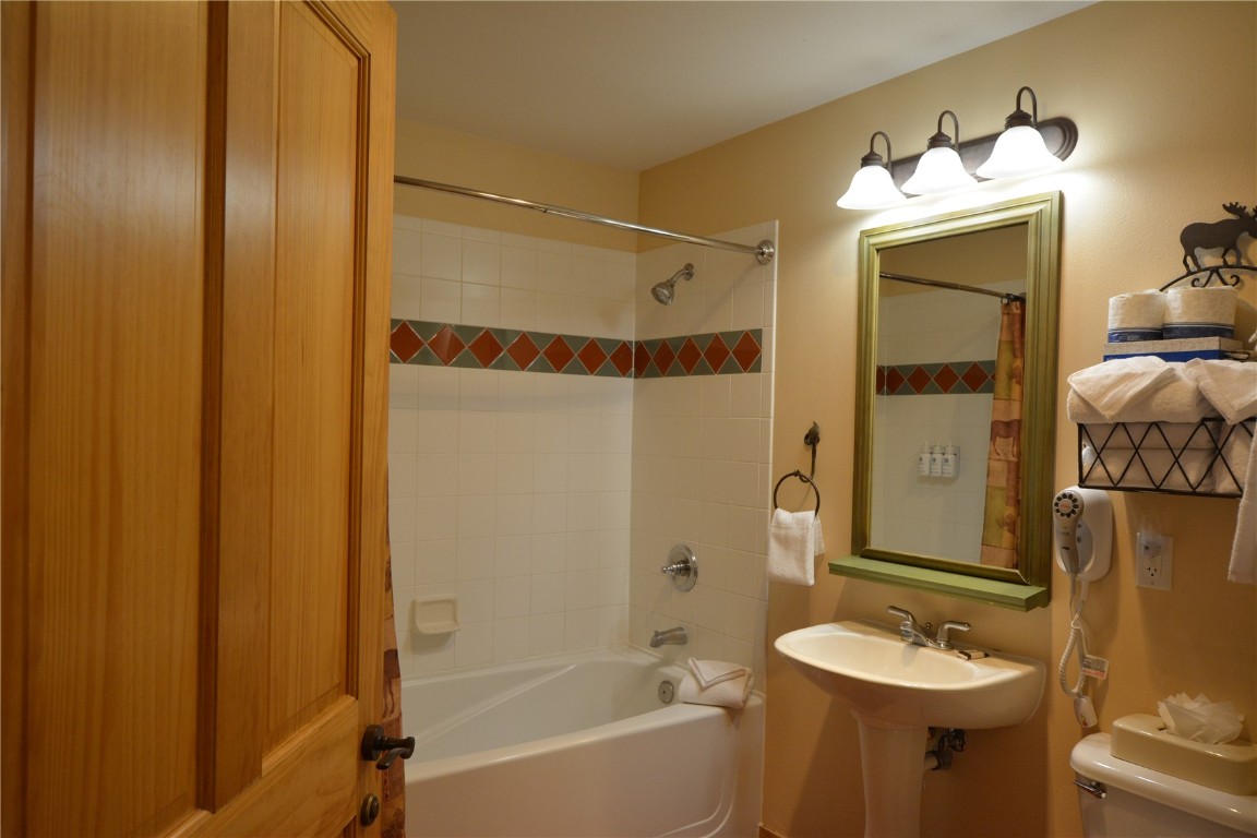 172 Copper Circle, Unit 107 Copper Mountain, CO 80443 - Photo 19 of 25 a bathroom with a tub shower sink and mirror
