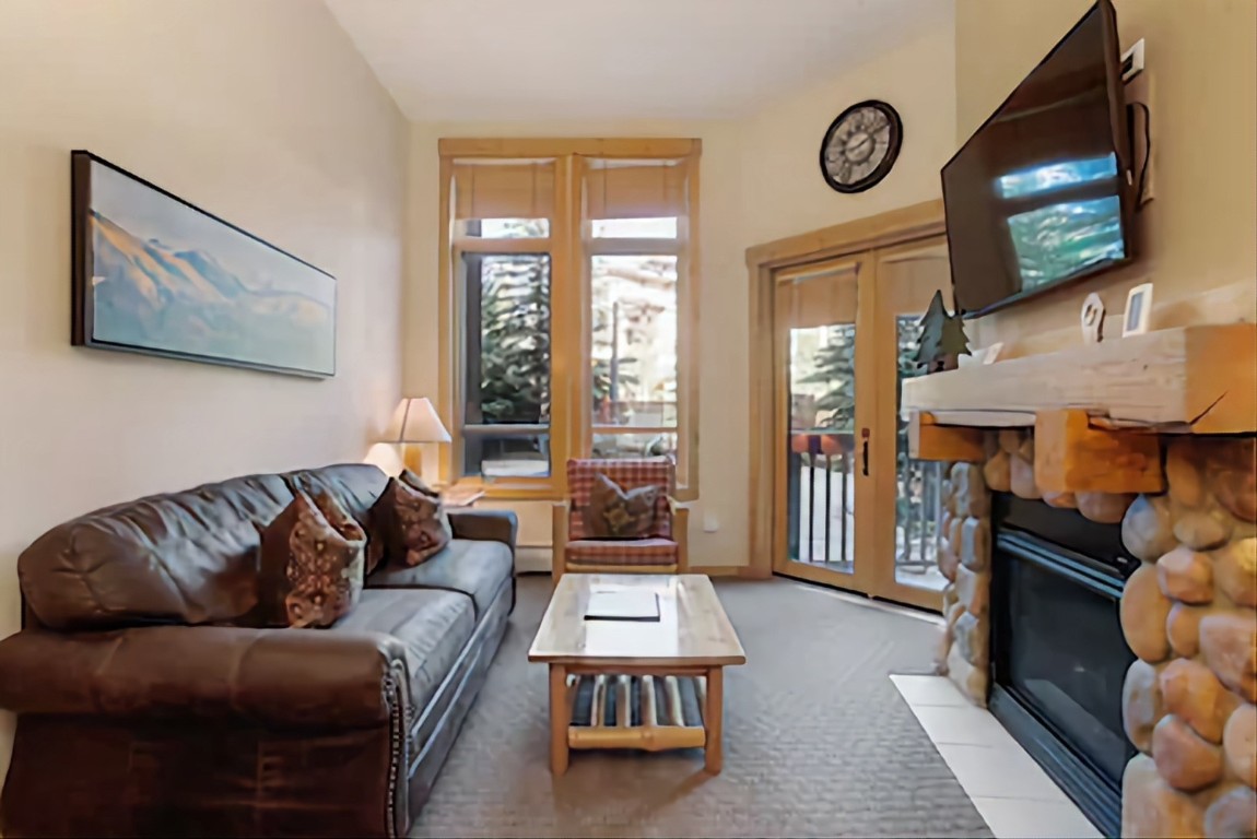 172 Copper Circle, Unit 107 Copper Mountain, CO 80443 - Photo 2 of 25 a living room with furniture a flat screen tv and a fireplace