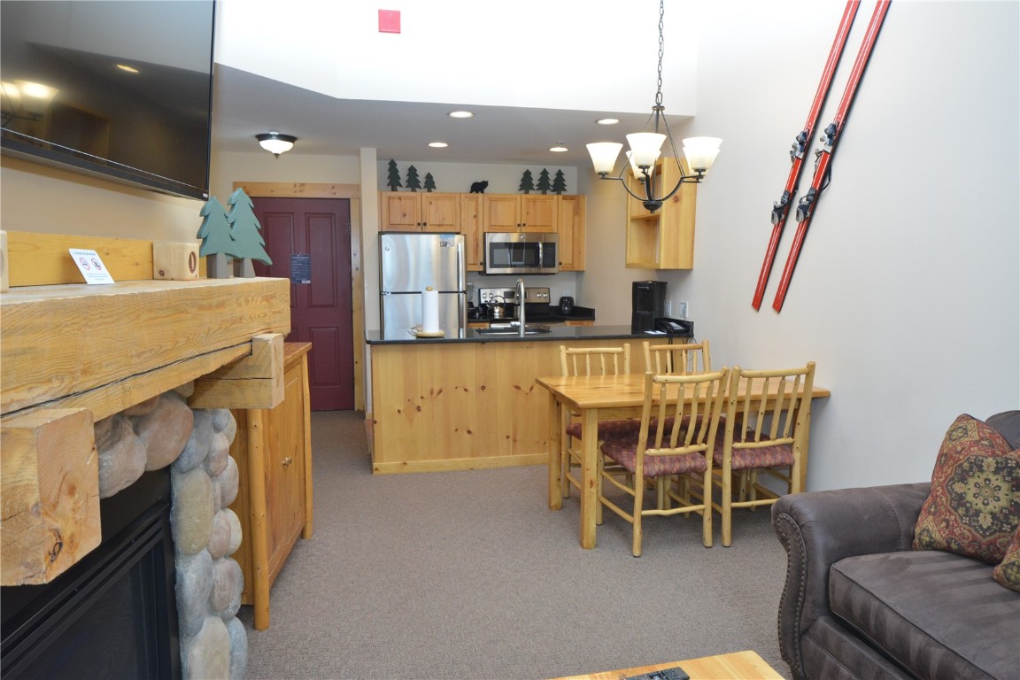 172 Copper Circle, Unit 107 Copper Mountain, CO 80443 - Photo 4 of 25 a dining room with furniture and a chandelier