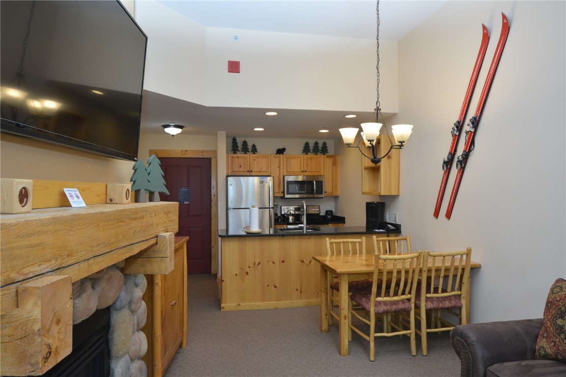 172 Copper Circle, Unit 107 Copper Mountain, CO 80443 - Photo 6 of 25 a dining area with a table chairs and a kitchen view