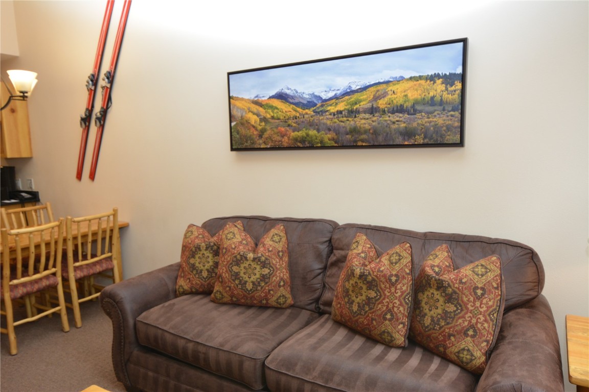 172 Copper Circle, Unit 107 Copper Mountain, CO 80443 - Photo 9 of 25 a living room with furniture a couch and a painting on the wall
