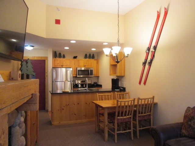 172 Copper Circle, Unit 107 Copper Mountain, CO 80443 - Photo 10 of 25 a dining room with furniture and a chandelier