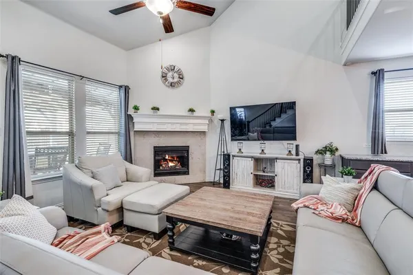 a living room with furniture a flat screen tv and a fireplace