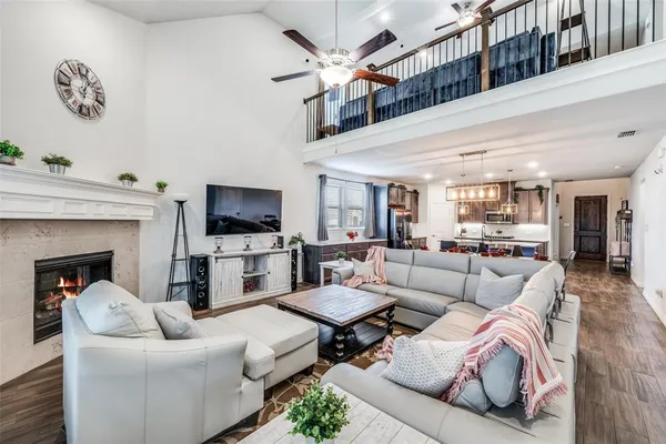 a living room with furniture a flat screen tv and a fireplace