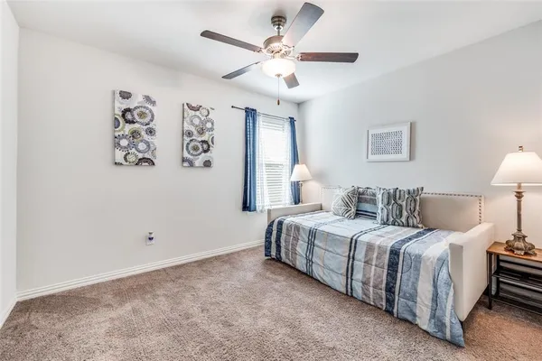 a bedroom with a bed and a lamp
