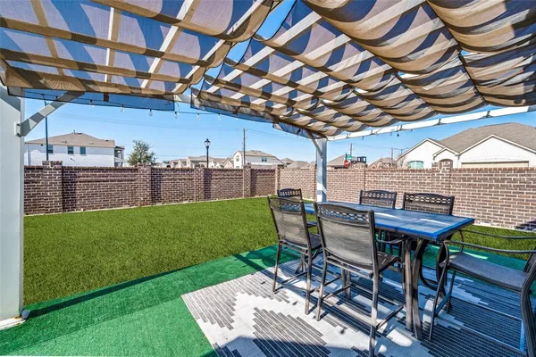 a view of a backyard with a patio and a garden