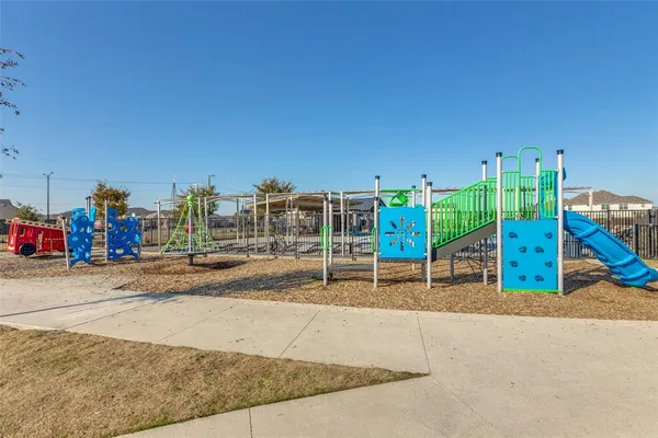 a view of a park with swings and slides
