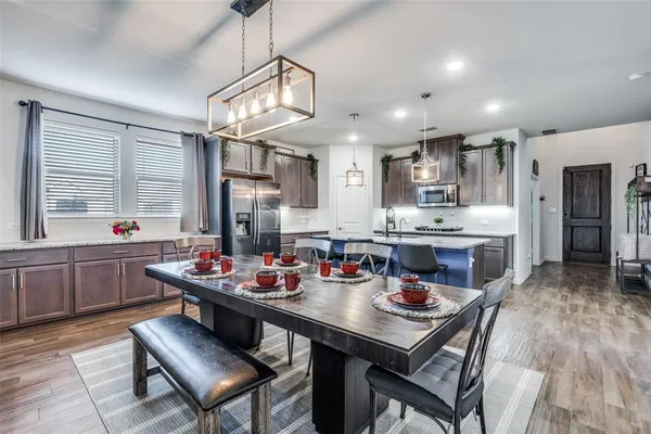a kitchen with a dining table and chairs