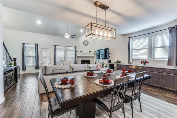 a view of a dining room with furniture a chandelier and wooden floor
