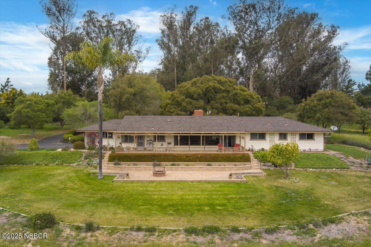 1740 Tularosa Road Lompoc, CA 93436 - Photo 2 of 55 a front view of a house with a yard table and chairs
