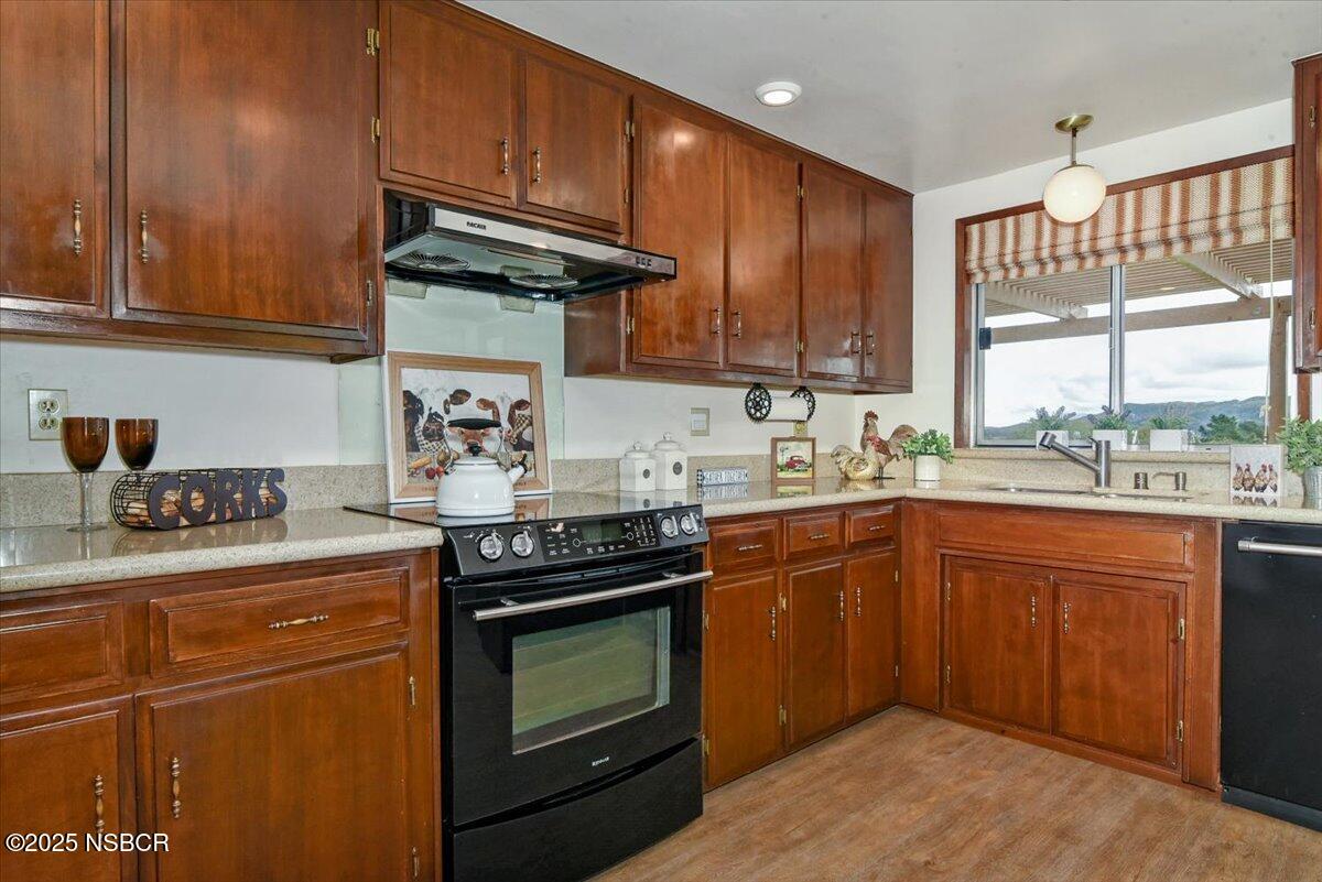 1740 Tularosa Road Lompoc, CA 93436 - Photo 21 of 55 a kitchen with granite countertop wooden cabinets appliances and a window