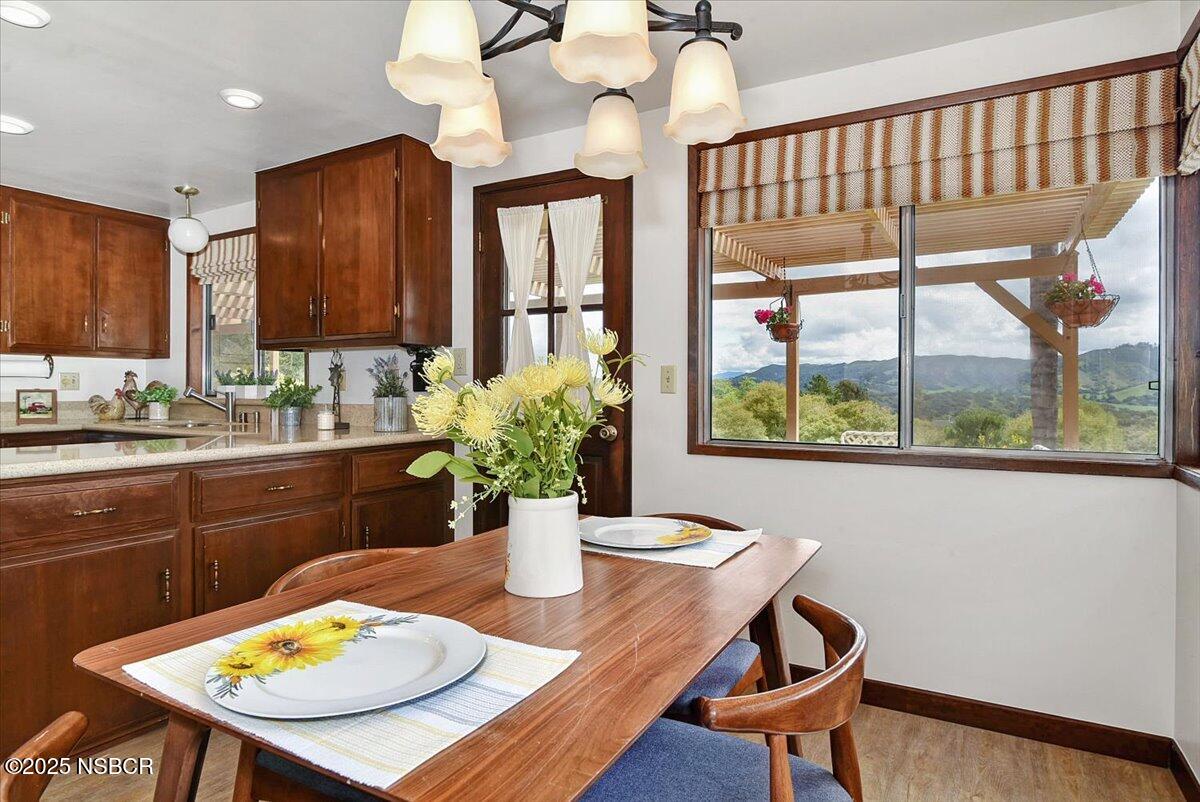 1740 Tularosa Road Lompoc, CA 93436 - Photo 25 of 55 a view of a dining room with furniture a chandelier and wooden floor