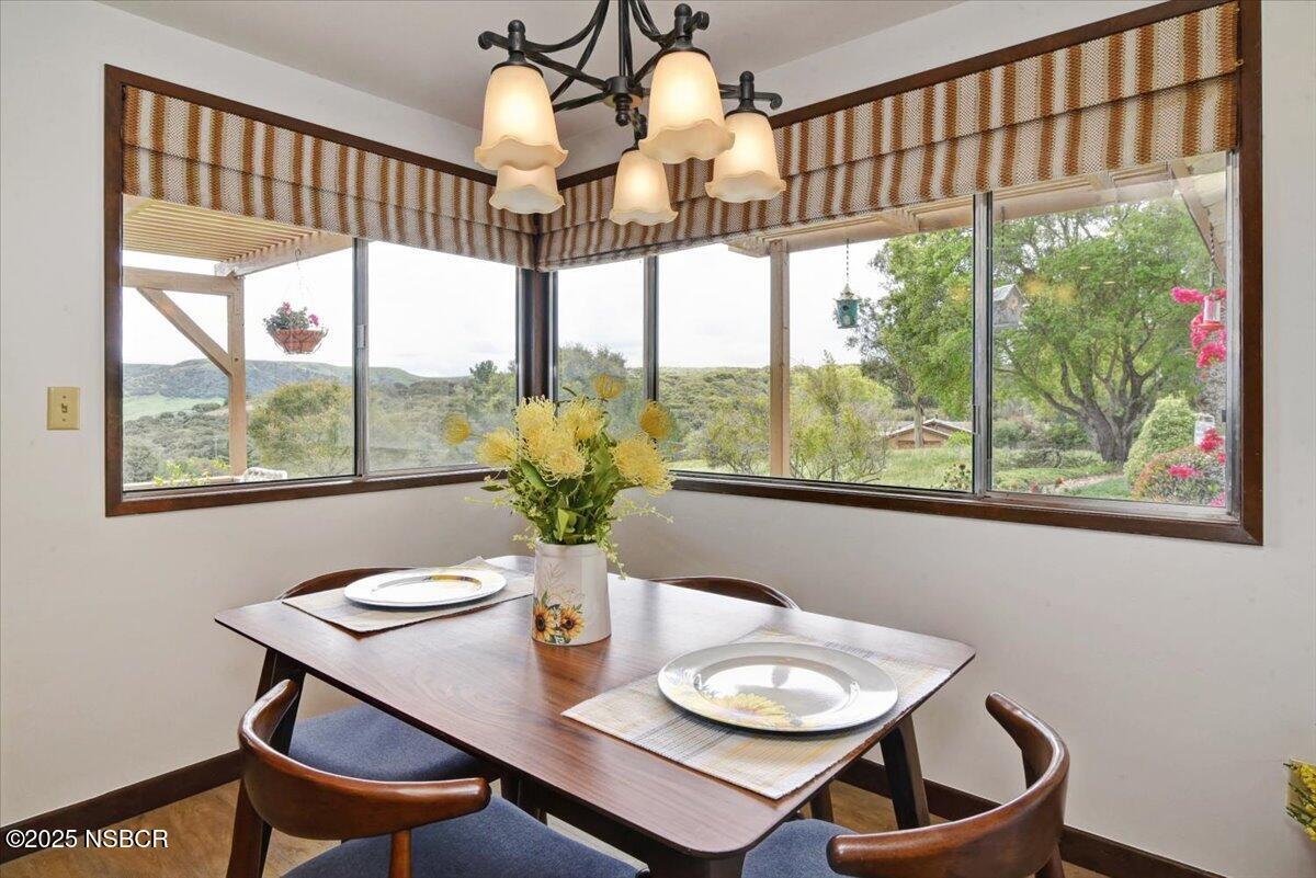 1740 Tularosa Road Lompoc, CA 93436 - Photo 26 of 55 a dining room with furniture a chandelier and wooden floor