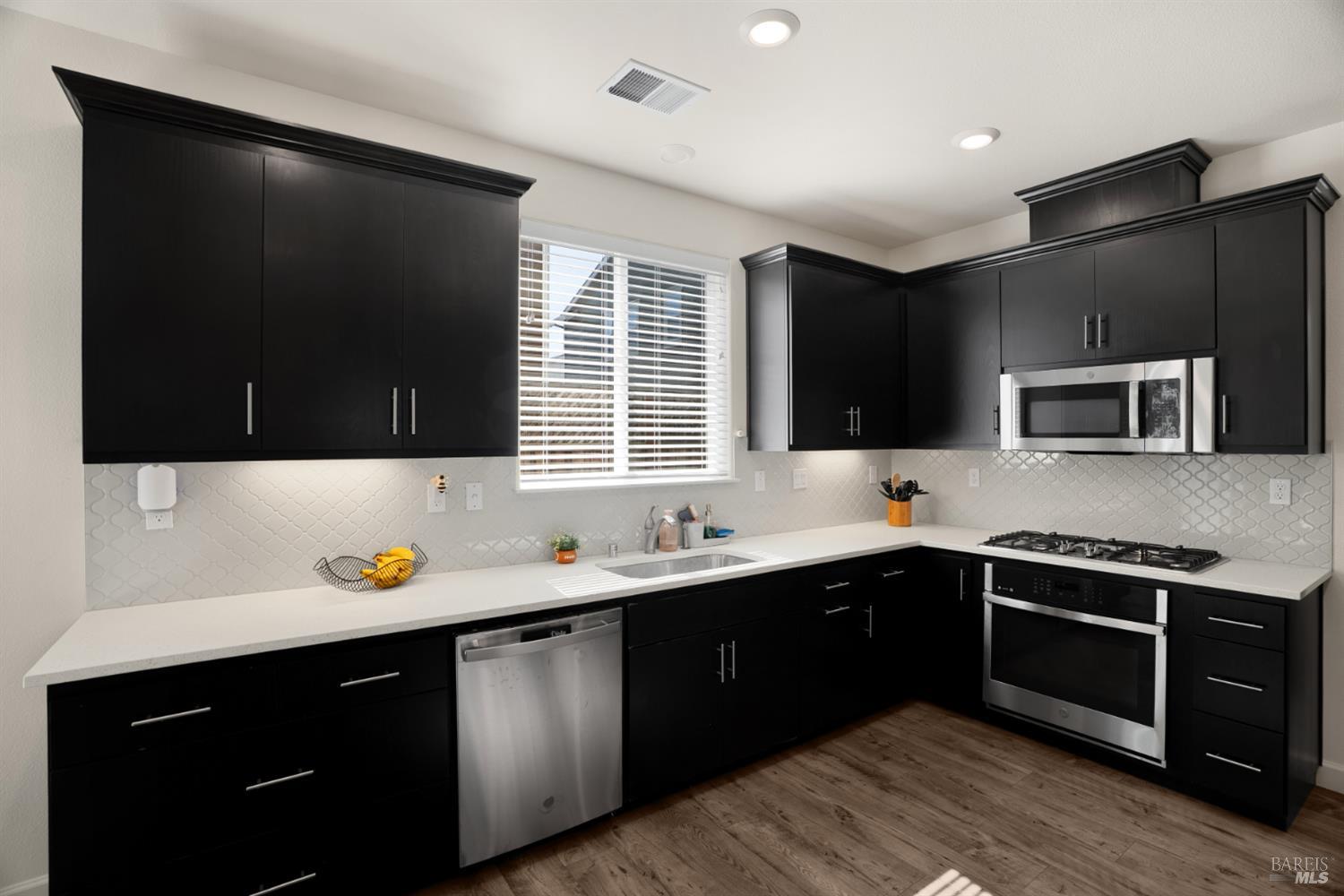 7465 Walker Way Rohnert Park, CA 94928 - Photo 12 of 43 a kitchen with stainless steel appliances a sink stove and microwave