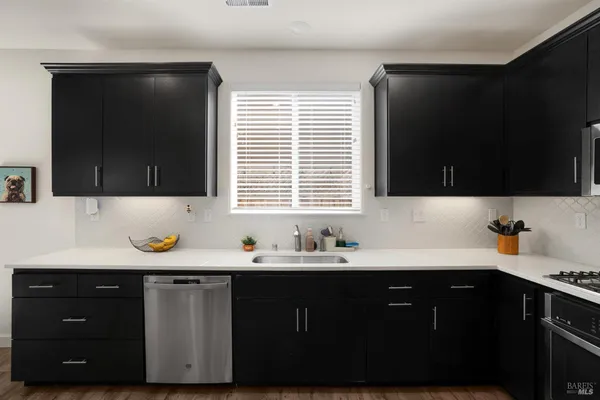 a kitchen with a sink and a window