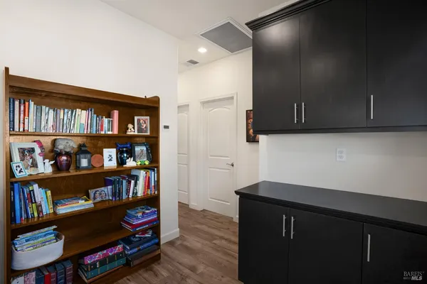 a kitchen with stainless steel appliances a cabinets and a book shelf