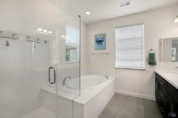 a white bath tub sitting in a bathroom next to a window