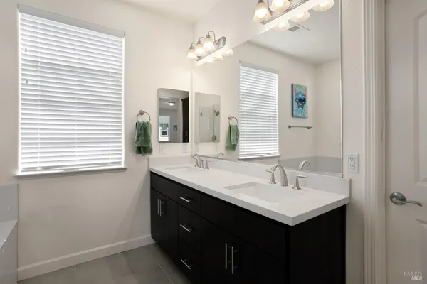 a bathroom with a sink double vanity and a mirror