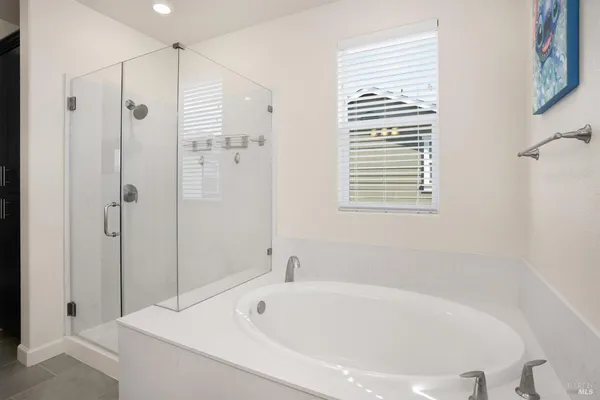 a bathroom with a bathtub and a shower