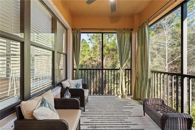 a balcony with furniture and a potted plant