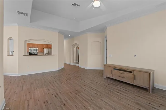 a view of a room with wooden floor and window