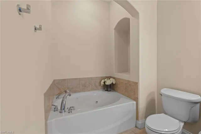 a white bath tub sitting next to a white toilet