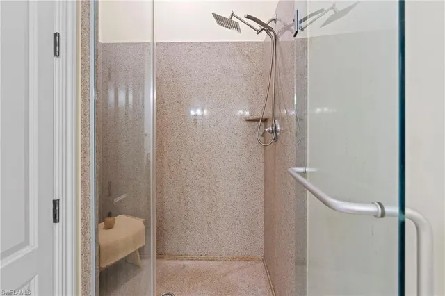 a bathroom with a glass shower door
