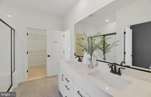 a bathroom with double vanity sink and mirror