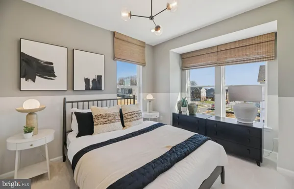 a bedroom with a bed and a mirror