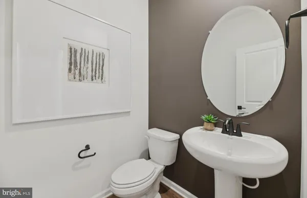 a bathroom with a sink a mirror and a toilet