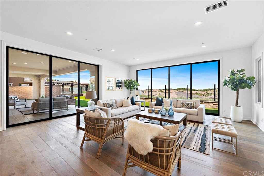 186 Leafy Pass Irvine, CA 92602 - Photo 17 of 59 a living room with furniture large window and wooden floor