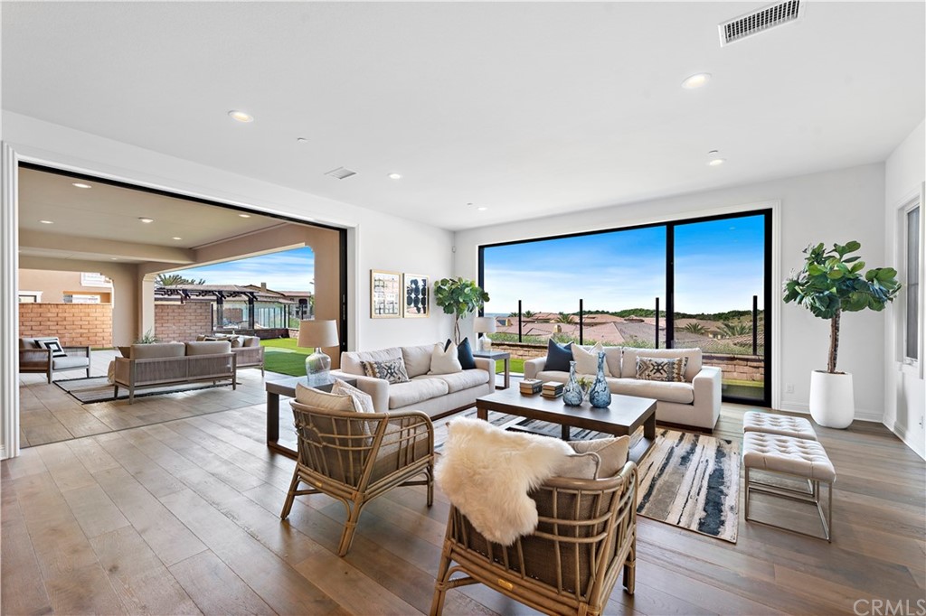 186 Leafy Pass Irvine, CA 92602 - Photo 18 of 59 a living room with furniture dining table and a large window