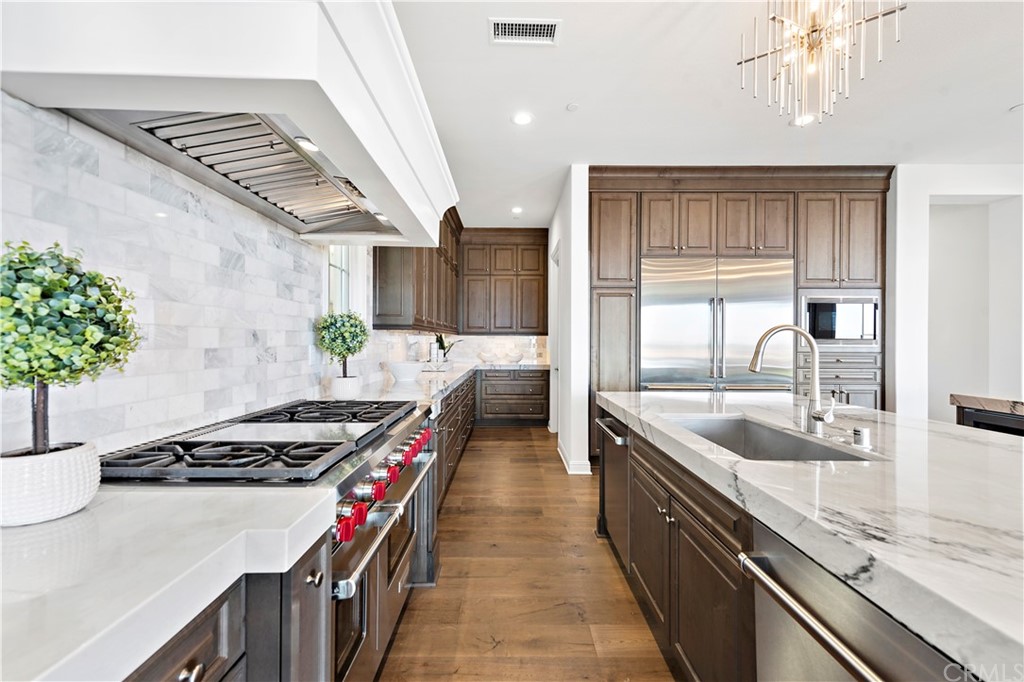 186 Leafy Pass Irvine, CA 92602 - Photo 21 of 59 a kitchen with stainless steel appliances granite countertop a sink stove and cabinets