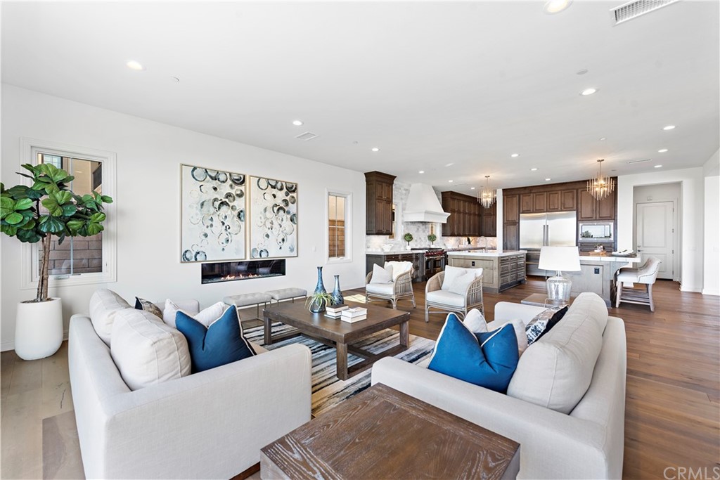 186 Leafy Pass Irvine, CA 92602 - Photo 25 of 59 a living room with furniture kitchen view and a potted plant