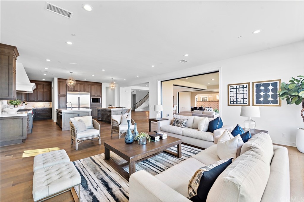 186 Leafy Pass Irvine, CA 92602 - Photo 26 of 59 a living room with furniture and wooden floor
