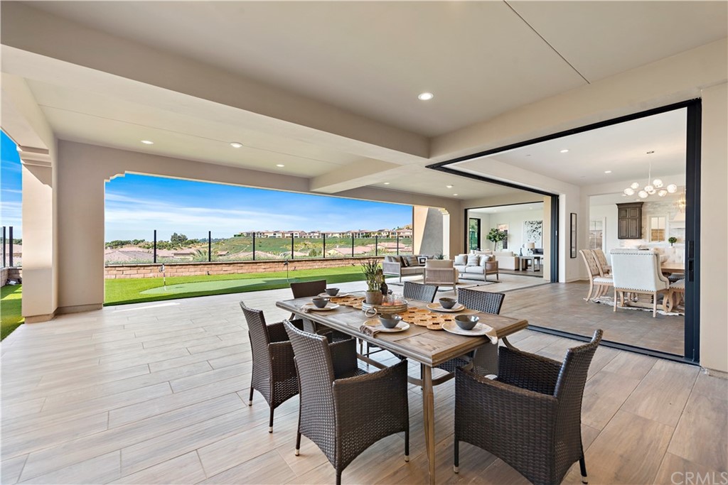 186 Leafy Pass Irvine, CA 92602 - Photo 28 of 59 a view of a dining room and livingroom with furniture wooden floor and a rug